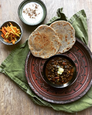 Gujarati vegetarian meal of urad dal, flatbread, yogurt and turmeric pickle.